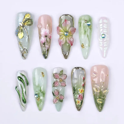 Decorative nail art with floral and leaf designs on a white background