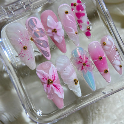 Set of pink and white butterfly-themed false nails in a clear case on a soft white background.