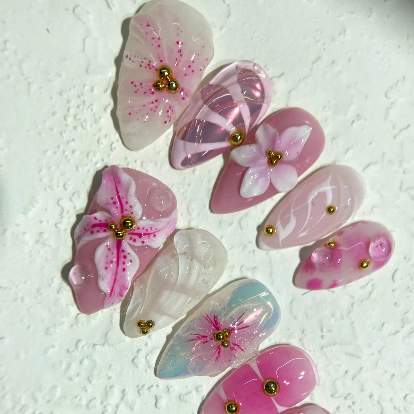 Decorative butterfly-shaped objects with floral patterns on a textured white background