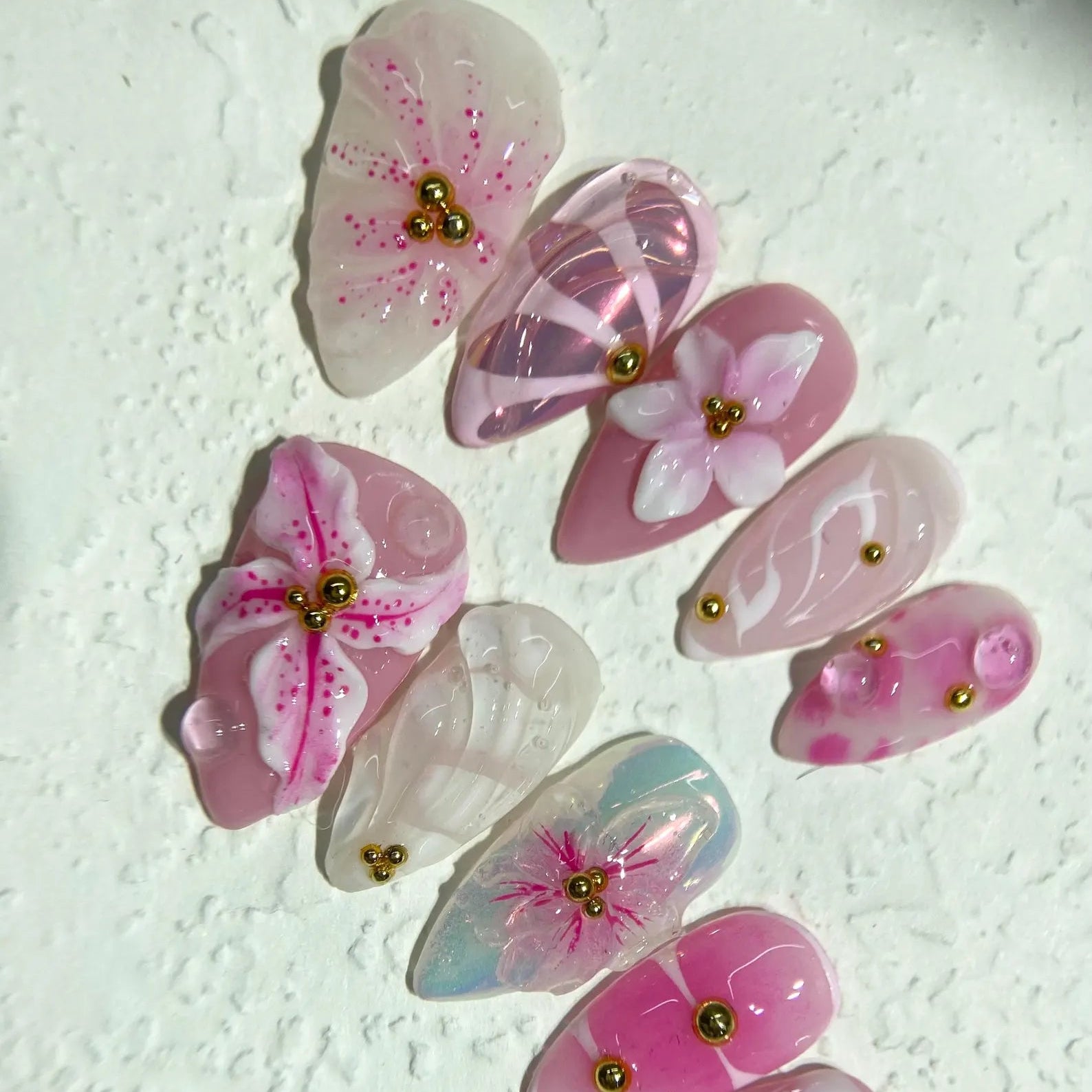 Decorative butterfly-shaped objects with floral patterns on a textured white background