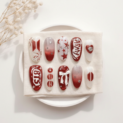 Set of red and white nail art designs on a white cloth with a natural background.