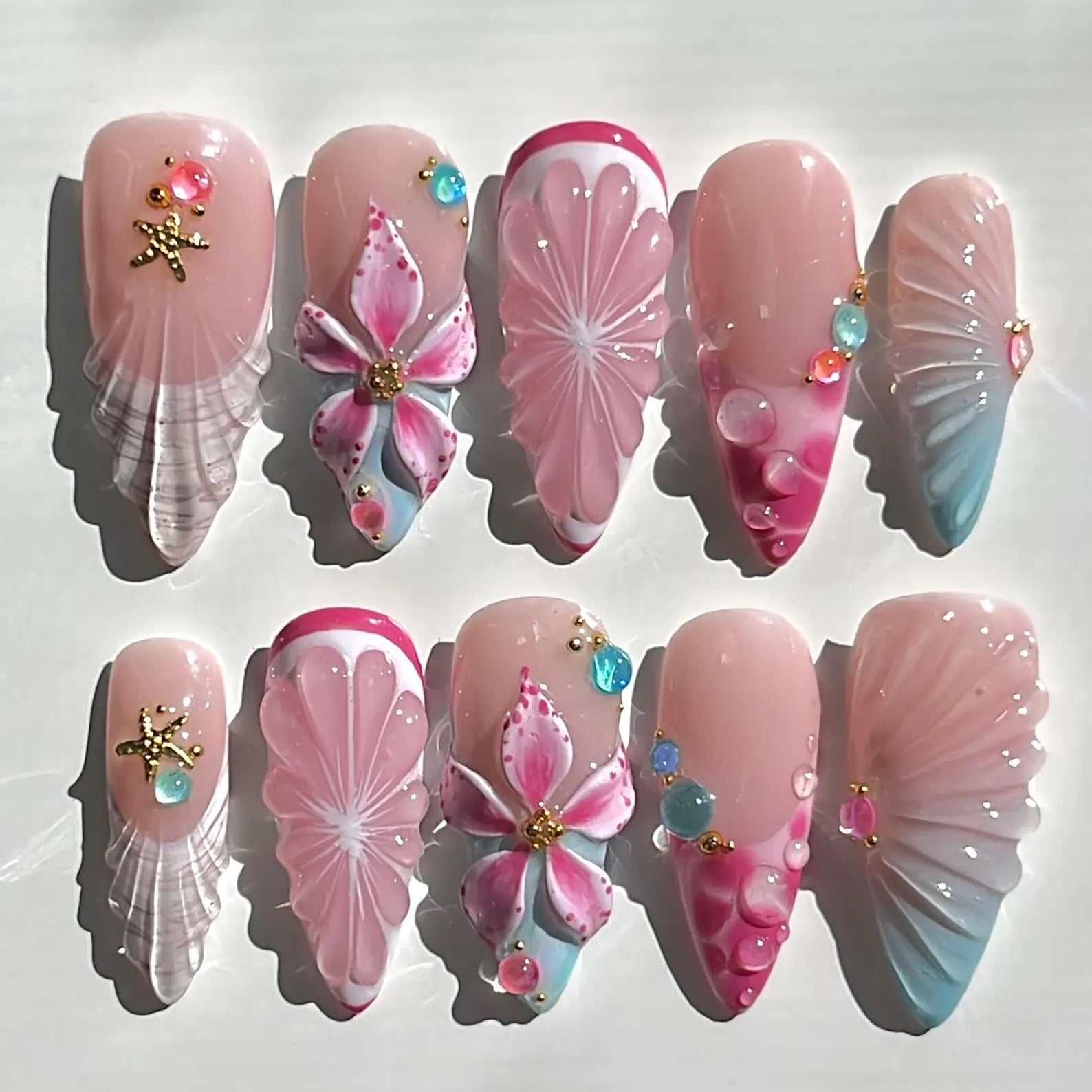 Decorative nail art with pink and white designs