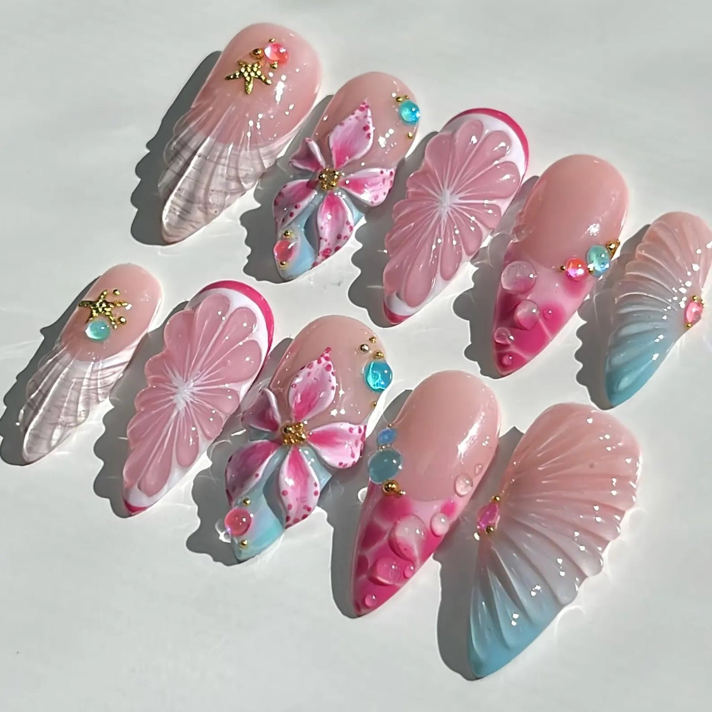 Decorative nail art designs with pink and blue flowers