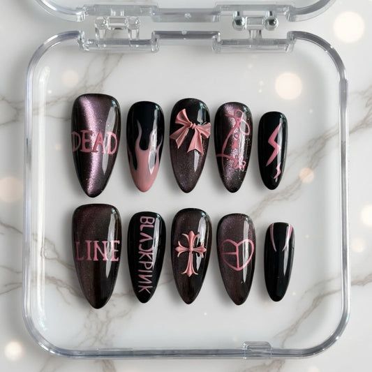 Set of black and pink nail art designs in a clear case on a marble background
